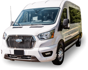 White passenger van with a large front grille and tinted windows, parked on a clear day.